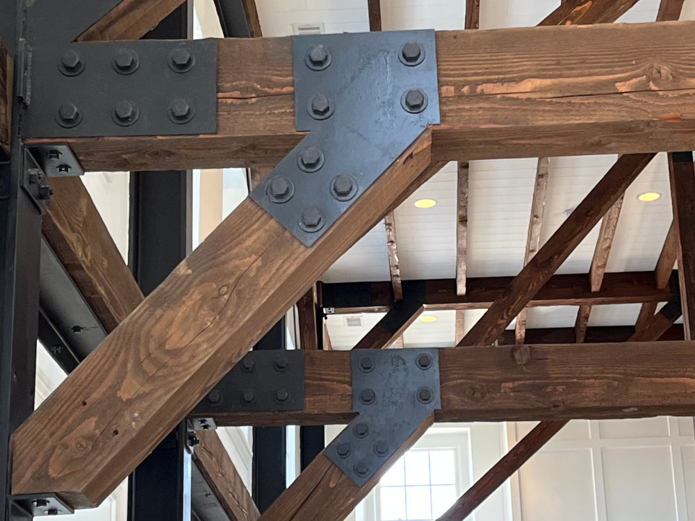 Exposed timber beams joined with precisely detailed steel plates